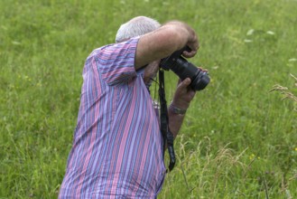 Older gentleman taking a photo, Bavaria, Germany, Europe