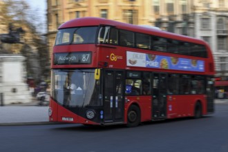 Red double-decker bus in Trafalgar Square, Westminster, London, England, United Kingdom, Europe