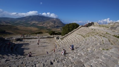 Evening light, Roman amphitheatre, few visitors in seats, Segesta, Ancient site, Archaeological