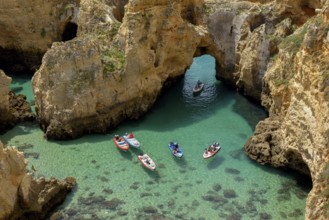 Excursion boats on the rocky coast near Lagos, Algarve, Portugal, Europe