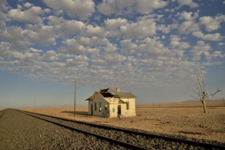 Derelict house by railroad tracks, former German railway station of Garub, Aus, Karas Region,