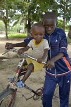 Two children with a bicycle, Nkala, Bandundu Province, Democratic Republic of the Congo