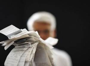 The subject of taxes. A man holds receipts in his hand in Berlin, 09/08/2024