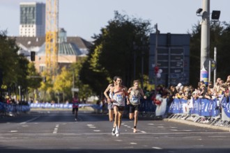 Runners, including Tom Gröschel Germany, on Potsdamer Platz at the 50th BMW Berlin Marathon 2024 on