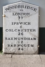 Old mile post marker with distances, Woodbridge, Suffolk, England, United Kingdom, Europe