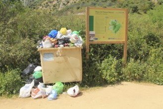 Overflowing rubbish bin at natural park, Cueva del Gato, Benaojan, Serrania de Ronda, Malaga