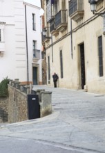 Old man with red cap walking in street, Caceres, Extremadura, Spain, Europe