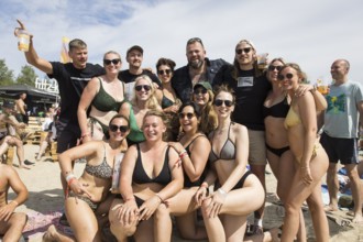 The band Feine Sahne Fischfilet having their photo taken with fans on the beach at the Highfield