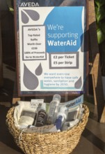 Aveda Corporation raffle supporting Water Aid charity shop window display, High Street,