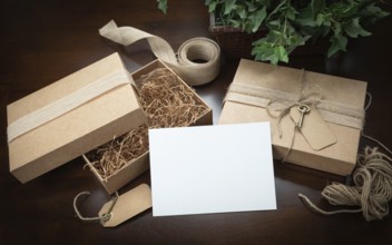 Gift packaging boxes mock up with jute string, blank card and tags with small key on wood surface