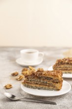 Walnut and hazelnut cake with caramel cream, cup of coffee on brown concrete background. side view,