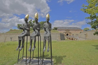 Sculpture Enthroned by Volkmar Kühn 2021, three bishops with golden mitres sitting on stools, row,