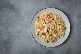 Tagliatelle pasta, in cream sauce with salmon, homemade, no people