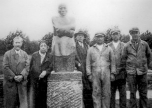 German artist Käthe Kollwitz posing with husband in front of sculpture group The Grieving Parents,