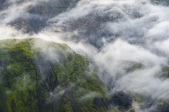 Fog, clouds moving around moss-covered mountains, impressive landscape, Pakgil, Iceland, Europe