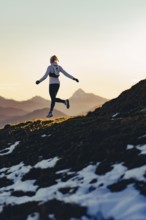 Trail running in autumn on the Jochberg on Lake Walchensee against the wonderful backdrop of the