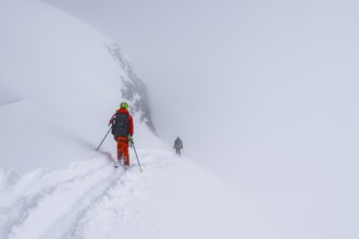 Ski tourers on the Wildhorn, Snowy mountain landscape and fog, Bernese Alps, Bernese Oberland,