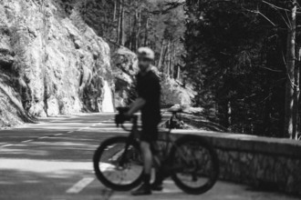 Road bike rider in spring in the Allgäu against the picturesque backdrop of the Alps, Bavaria,