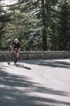 Road bike rider in spring in the Allgäu against the picturesque backdrop of the Alps, Bavaria,