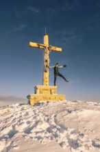 Summit bliss in the snow-covered winter landscape in the Tannheimer Tal in the Alps on the