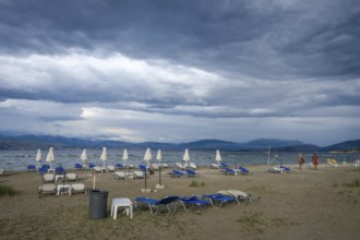 Kalamaki, Corfu, Greece, Sun loungers and parasols on Kalamaki beach in the north-east of the Greek