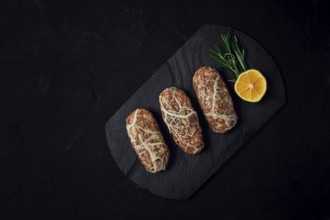 Traditional Cypriot Seftalia dish, raw, top view, on a black background, no people