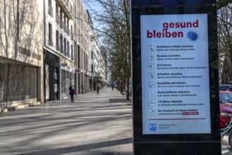 Advertising displays, on Königsallee, Kö, give advice on correct behaviour, empty city centre,