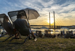 The city beach on the Rhine near Düsseldorf, riverside promenade, by the Rheinkniebrücke bridge,