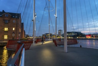 Cyclists on the Cirkelbroen cycle and pedestrian bridge, over the harbour, in the Christianshavens