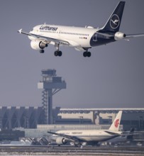 Lufthansa Airbus A319-100 approaching Frankfurt FRA airport, air traffic control tower, Fraport, in