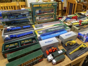 Boxes of Eddie Stobart model trucks and other vehicles on display at auction, UK