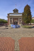 Renovation work on the historic Berliner Tor city gate with street trees and buildings on