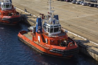 High angle view of docked orange, white and blue Capo D'Orlando and Megrez tugboats, Port of