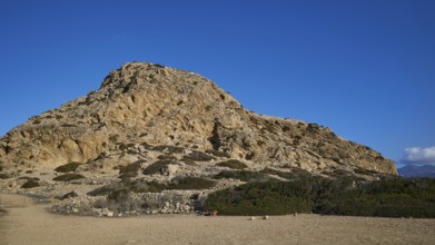 Rocky hill with sparse vegetation under a clear blue sky, Acropolis Hill, Arkasa, west coast,