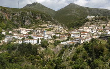 View of village of Dhermi, Albania whitewashed buildings on mountainside