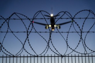 Symbolic image security at the airport, outer fence at Düsseldorf International Airport, steel wire