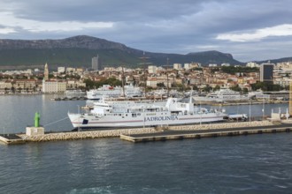 White blue and red Jadrolinija Oliver ferry boat docked at terminal in Port of Split in late