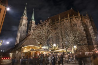 Christmas lighting at the Bratwursthäusle near St. Sebald, St. Sebald Church in the background,