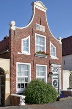 Historic building at the harbour of Greetsiel, blue sky, North Sea, Lower Saxony, Germany, Europe