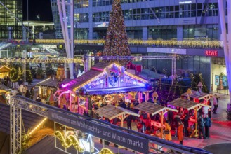 Christmas market at the airport in the evening, market stalls decorated for Christmas in front of