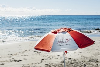 Lonely beach and parasol, Spiaggia di Biderosa, Riserva Biderosa nature reserve, Orosei, Nuoro