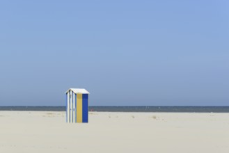 Blue and yellow cottage, beach shower on the extensive sandy beach, blue sky, North Sea, Juist,