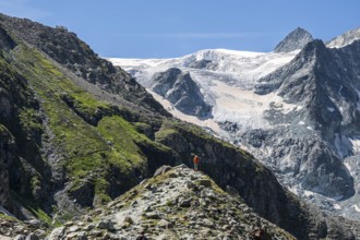 Hiking path up to mountain hut Cabane de Moiry, hiking tourist, Moiry glacier in the back, Valais,