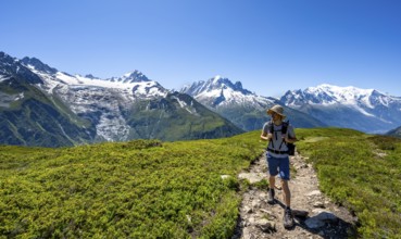 Mountaineer in front of mountain panorama with glaciated mountain peaks, Aiguille de Chardonnet