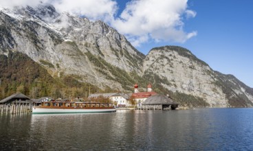 Königssee with Watzmann massif and pilgrimage church St. Bartholomä with tourist boat, autumnal