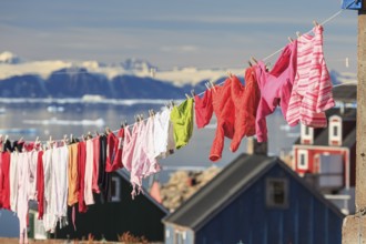 Colourful laundry drying on a washing line in an Inuit settlement, Ittoqqortoormiit, Scoresby Sund,