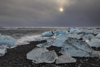 Ice floes on the beach, waves, sea, clouds, sunlight, winter, Diamond Beach, Breidamerkursandur,