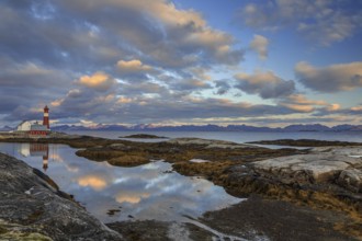 Lighthouse reflected in water, cloudy mood, mountains, coast, Tranoy, Ofoten, Norway, Europe