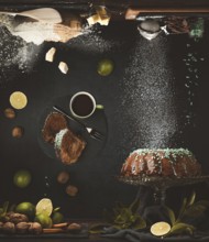 Still life with a cake with chocolate icing surrounded by limes, nuts, cup with coffee, baking