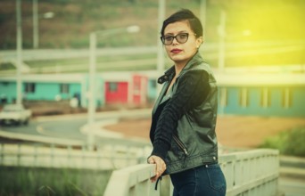 Portrait of Latin girl glasses looking at camera. Beautiful Latin girl with jacket smiling at